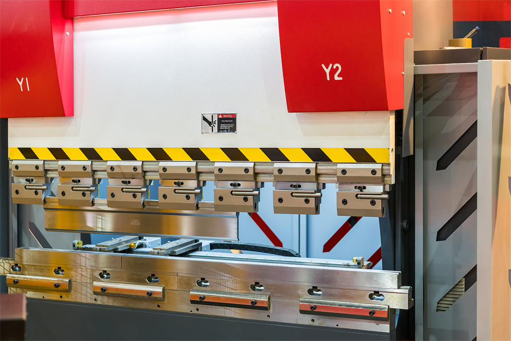 Close-up of metal sheet bending machine teeth and tooling