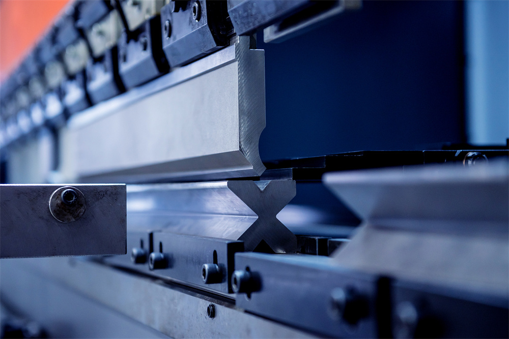 Modern hydraulic bending machine in a metal factory showing backgauge assembly