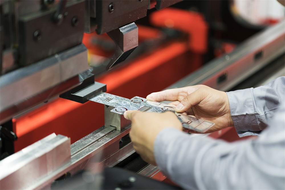 Close-up of a CNC press brake bending a metal sheet