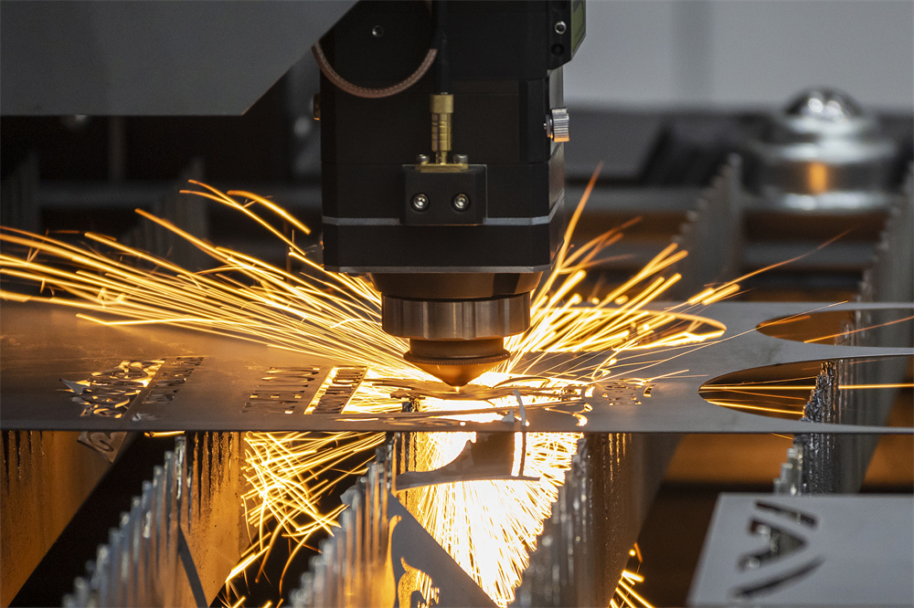 Fiber laser cutting head processing a metal sheet with sparks flying