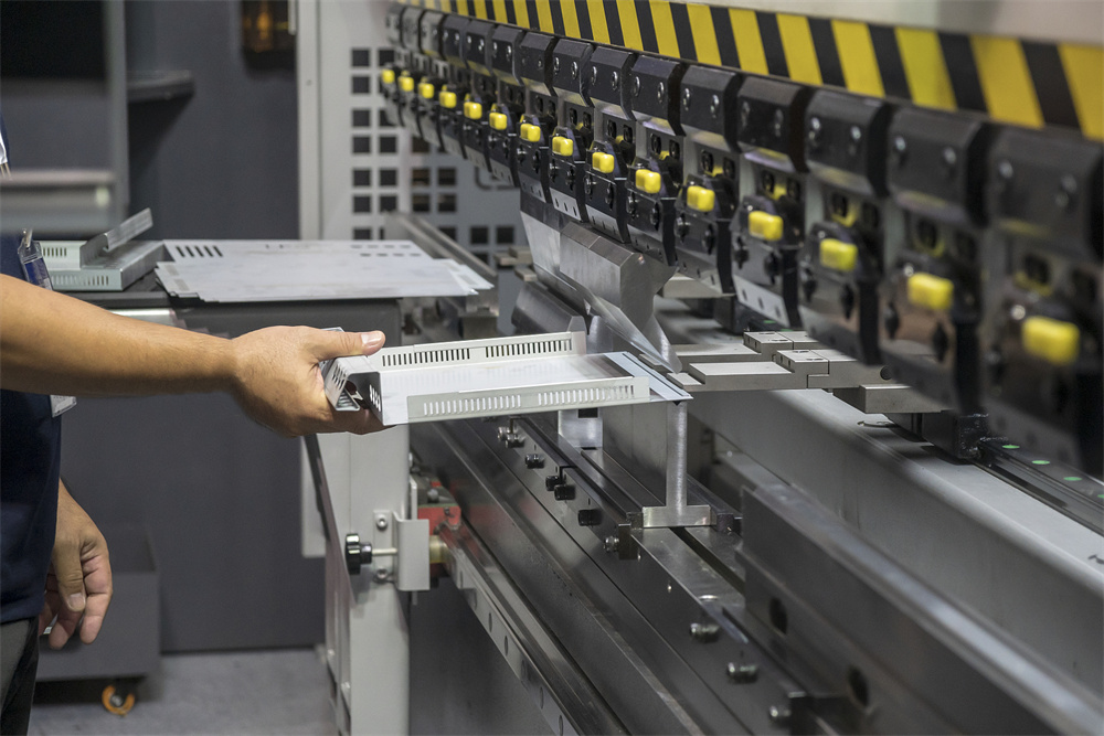 Technician inspecting a HARSLE hydraulic press brake for calibration errors