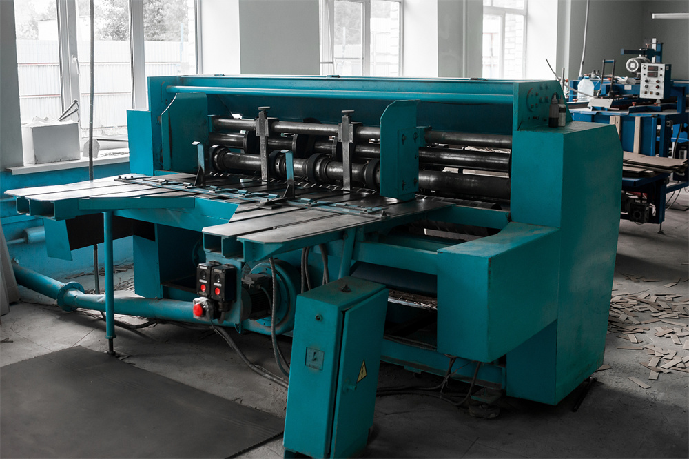 Industrial shearing machine in a metal fabrication workshop